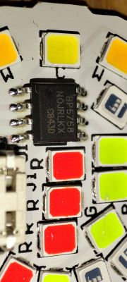 Close-up of a BP5758 integrated circuit on a PCB with colored LED lights.