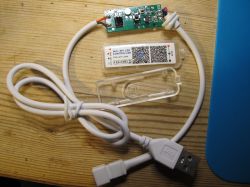 WiFi SPI LED Controller WiFi SPI LED Controller with USB cable on a wooden table