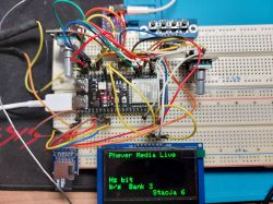 Breadboard with an OLED display and various connected wires.