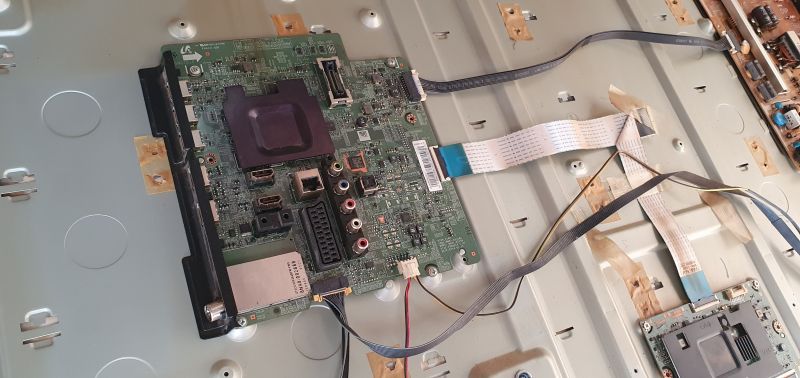 TV mainboard with visible HDMI, SCART, AV ports and flat ribbon cables