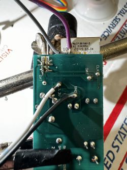 Circuit board with wires soldered for firmware flashing of the integrated circuit.
