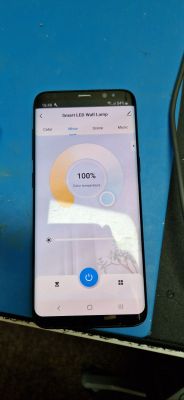 Smartphone displaying an app for controlling a smart LED lamp, showing color temperature settings.