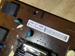 Part of a PCB with markings and electronic components.