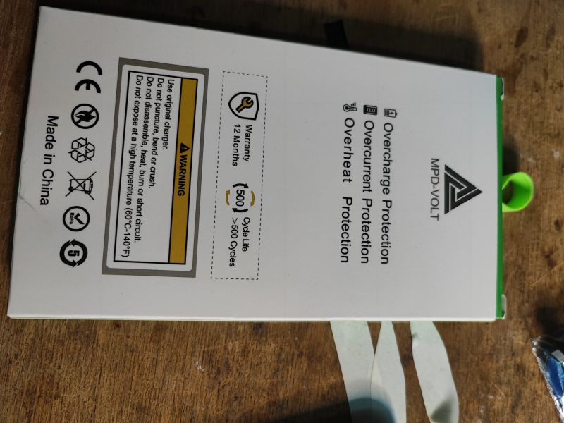 Replacement iPhone Battery with Safety Features iPhone replacement battery with warning label.