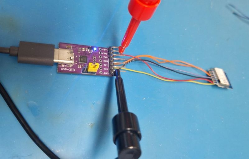 USB-2TTL CH342 module connected to device using multicolored wires