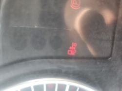 Red brake system warning light on a car dashboard, indicating a brake system or brake fluid issue.