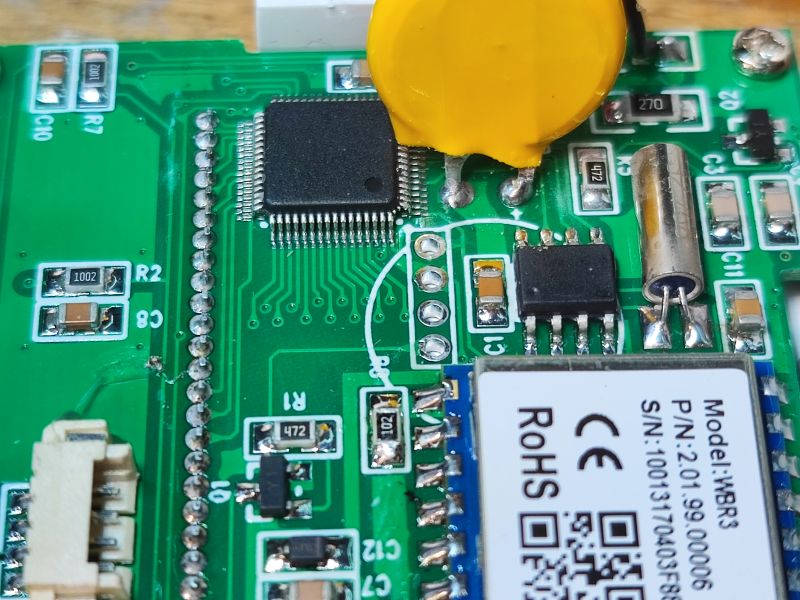 Close-up of a PCB with WBR3 Wi‑Fi module, IC chip, and a yellow disc capacitor