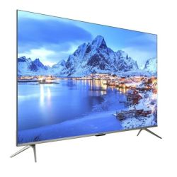 Flat-screen TV displaying snowy mountain landscape with village lights