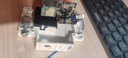 TOSR02T wireless relay with exposed ESP8266 and circuit board Disassembled TOSR02T relay device with visible ESP8266 module and PCB