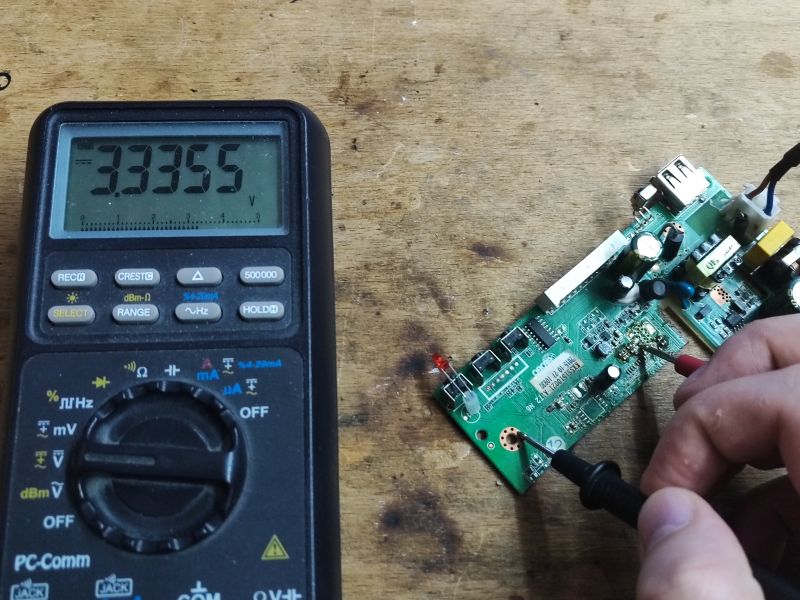 Voltage Measurement on PCB with Multimeter Multimeter measuring voltage on a PCB