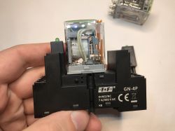 Przekaźnik elektromagnetyczny F&amp;F GN-4P trzymany w dłoni