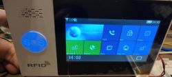 Control panel display with SOS button and security functions.
