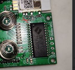 Close-up of a circuit board with highlighted soldering paths.