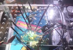 Electronic circuit on a transparent panel with multiple wires and diodes.