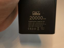 Close-up of NXT Gear BY-K8 power bank showing 20000 mAh and port specs