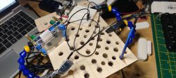 Breadboard setup with electronic components and wires connected to a laptop.