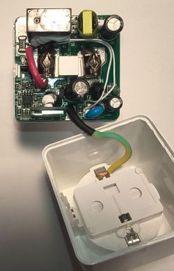 Open electric socket showing circuit board and internal wiring.
