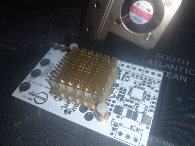 Circuit board with a mounted heatsink and cooling holes.