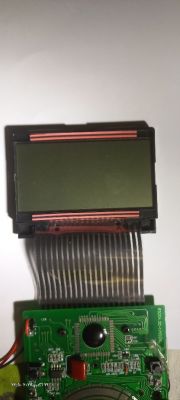 LCD display connected to a circuit board with a ribbon cable.