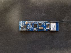 Electronic Module with Antenna Electronic module on a black background with an antenna.