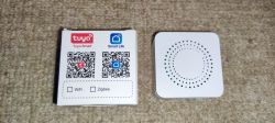 White square Tuya switch with a dotted pattern and packaging with QR codes.