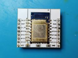 C-8133U module soldered onto an ESP-12E board on a blue background.