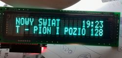 VFD display showing text NOWY ŚWIAT T - PION I and time 19:23.