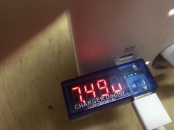 USB Meter Display Showing 7.49 V Display of a meter with a connected USB cable showing 7.49 V.
