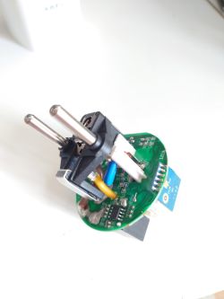 Inside of an Electrical Plug with Circuit Board Disassembled electrical plug with visible circuit board and wires.