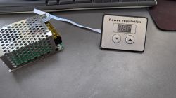 Power regulation module with control interface Power module with metal casing and control panel with display and buttons.