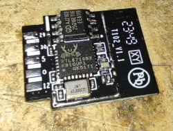 Close-up of an electronic module with an RTL8710BX chip on a PCB.