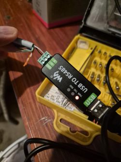 USB to RS485 adapter connected to wires, with visible red PWR LED indicator.