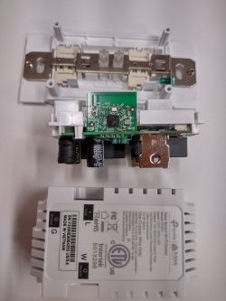 Dismantled TP-Link Kasa Smart Wi-Fi outlet showing the integrated circuit and PCB.
