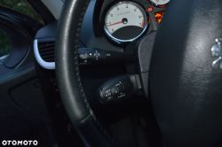 Car steering wheel with column stalks and tachometer on the instrument cluster