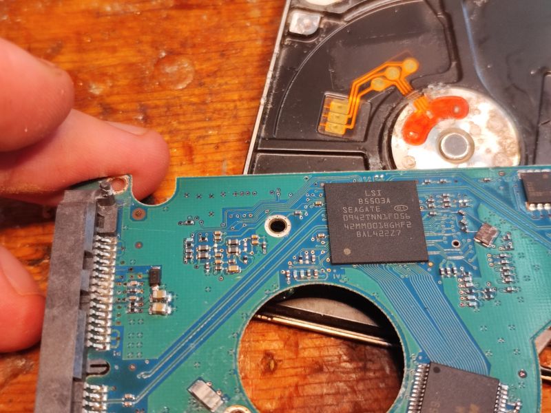 Inside of Hard Drive with Visible Electronics Image of a hard drive interior showing the PCB board.
