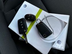 Car keys lying on a Volkswagen manual.