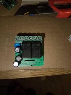 Relay module with two relays and screw terminals on a green PCB