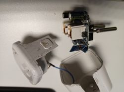 An opened electrical adapter with visible circuit board and electronic components.