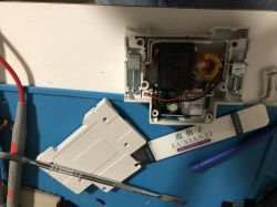 Dismantling IMMAX NEO Smart Electronic Device Opened electronic device on a blue work mat with disassembly tools.