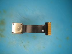 FPC ribbon cable with gold-plated connector and metal end on a blue surface