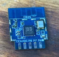 Photo of a Tuya CB2S module with a visible BK7231N chip on a wooden background.