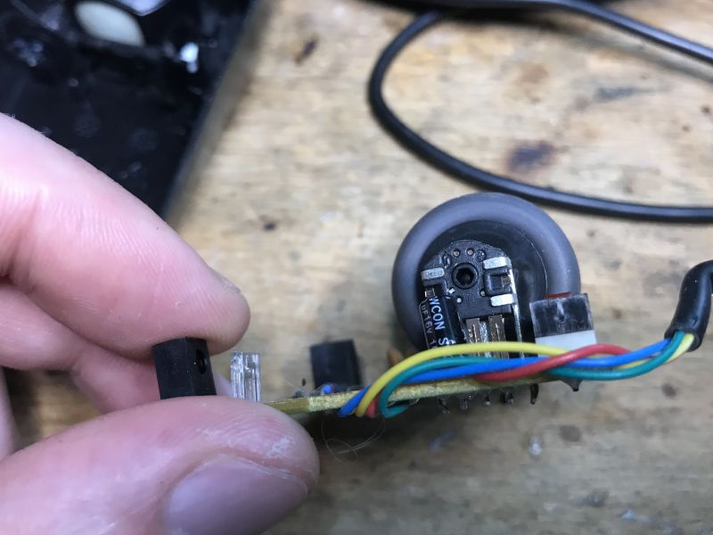 Inside of an Old Computer Mouse Inside of an old computer mouse with a visible encoder and colored wires