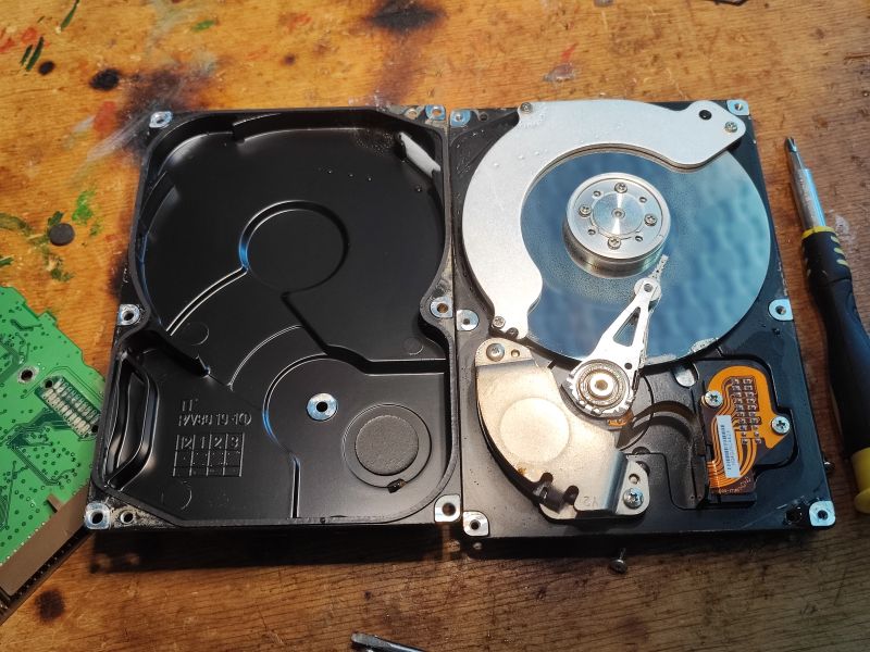 Interior of an Open Hard Drive Interior of an open hard drive with visible platter and PCB