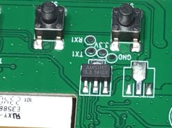 PCB with Buttons and AMS1117 Chip Close-up of a PCB with two buttons and an AMS1117 chip.