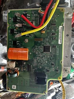 Power steering control unit with exposed PCB and connected wires
