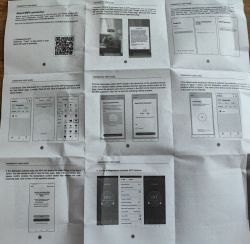 Photo of a folded “THERMOSTAT USER GUIDE” sheet with a QR code and app setup phone screenshots