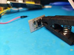 CR3L Module Clamped in Vise CR3L electronic module with components clamped in a vise on a blue background.