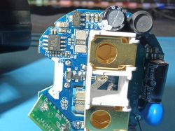 Close-up of an electronic circuit board with connectors Close-up of a blue PCB with SMD components, two connectors, and electrolytic capacitors