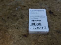 Sonoff DW2-Wi-Fi Sensor Packaging Sonoff DW2-Wi-Fi sensor packaging on a wooden surface.