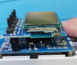 Circuit board with mounted LCD display and additional electronic components.